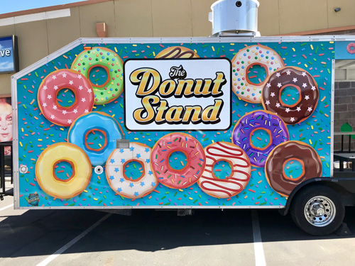 The Donut Stand food trailer with custom printed business graphics.